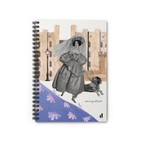 Notebook with vintage-style illustration of a woman and dog, set against a cityscape background.
