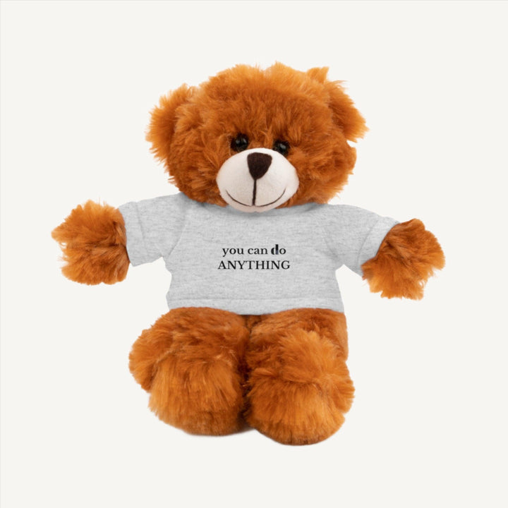 8-inch teddy bear wearing a gray t-shirt with the motivational message 'you can do anything' printed on it, ideal cuddly companion for inspiring positivity and comfort. mental health plushie, mental wellness stuffed animal