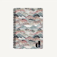 Immerse yourself in the serenity of nature with our abstract spiral ruled line notebook journal, capturing the essence of majestic mountains, expansive sky, and fertile earth. With a timeless boho theme, this notebook showcases calming blue hues complemented by accents of vibrant red, adorned with intricate mountain, cloud, and earthy motifs. Ideal for journaling your musings, sketches, and creative ideas with an enchanting touch!